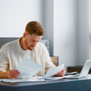 corporate-manager-looks-at-sheets-of-papers-with-r-5CJCPLB How to Host a Stellar Event on a Tight Budget